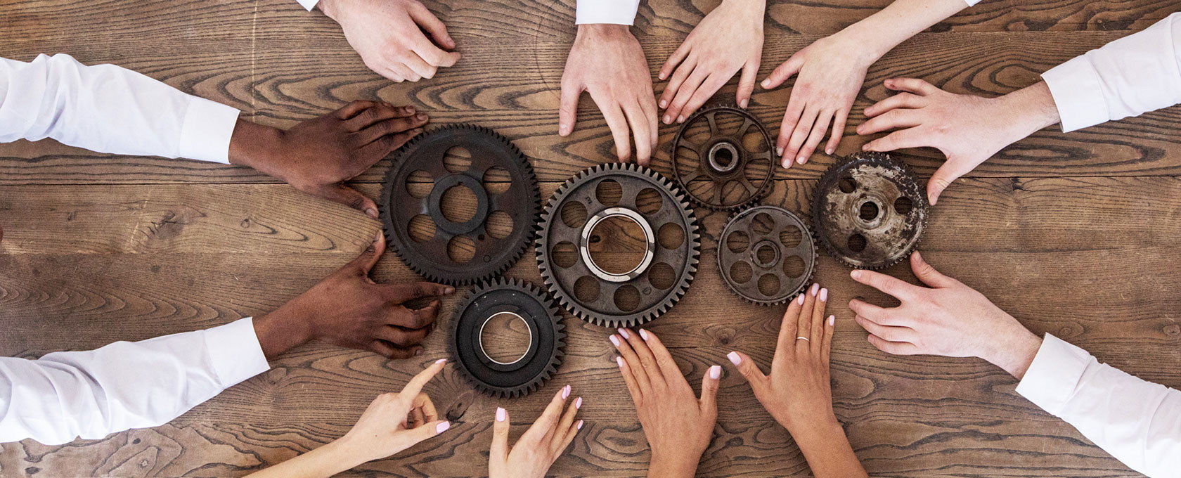 hands and gears on table